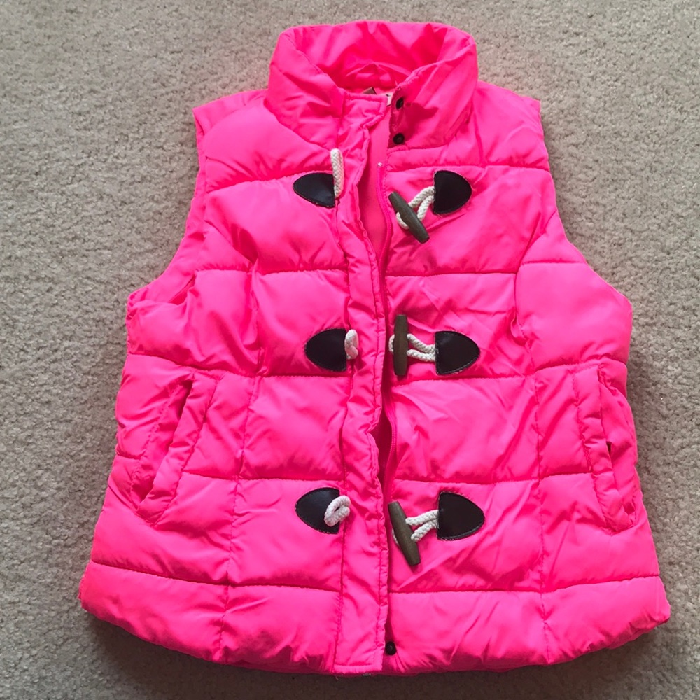 Bright pink puffer vest with wood and rope closure